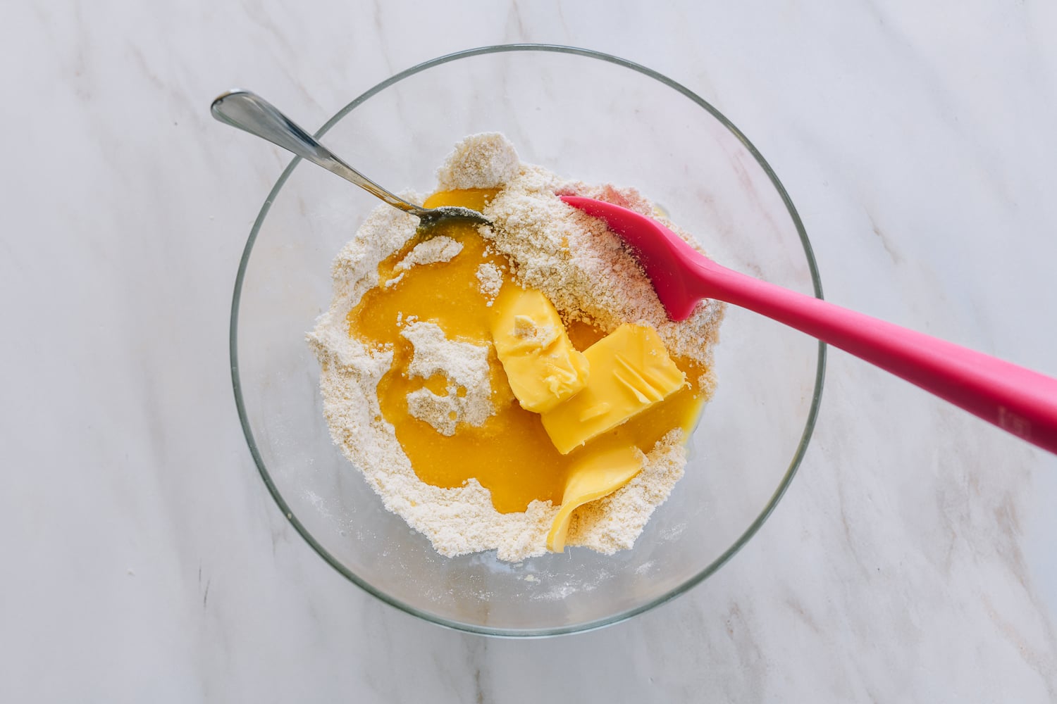 adding butter and wet ingredients to dry ingredients