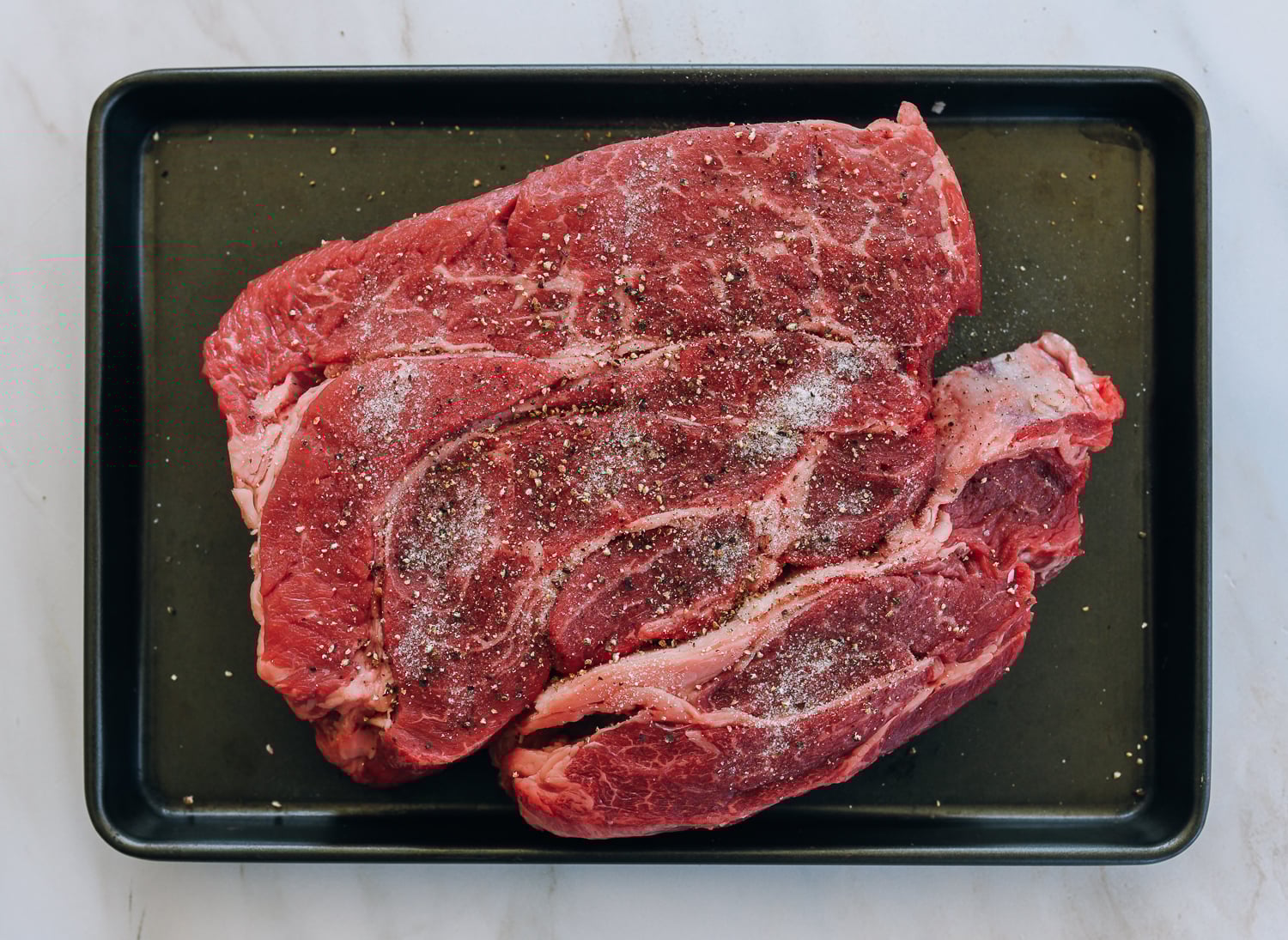 chuck roast seasoned with salt and pepper