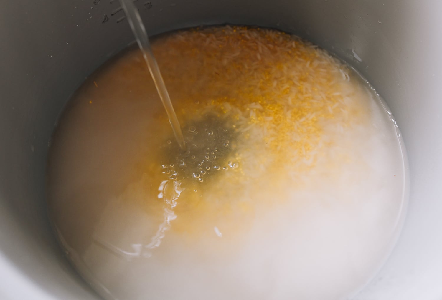 adding water to rice and millet