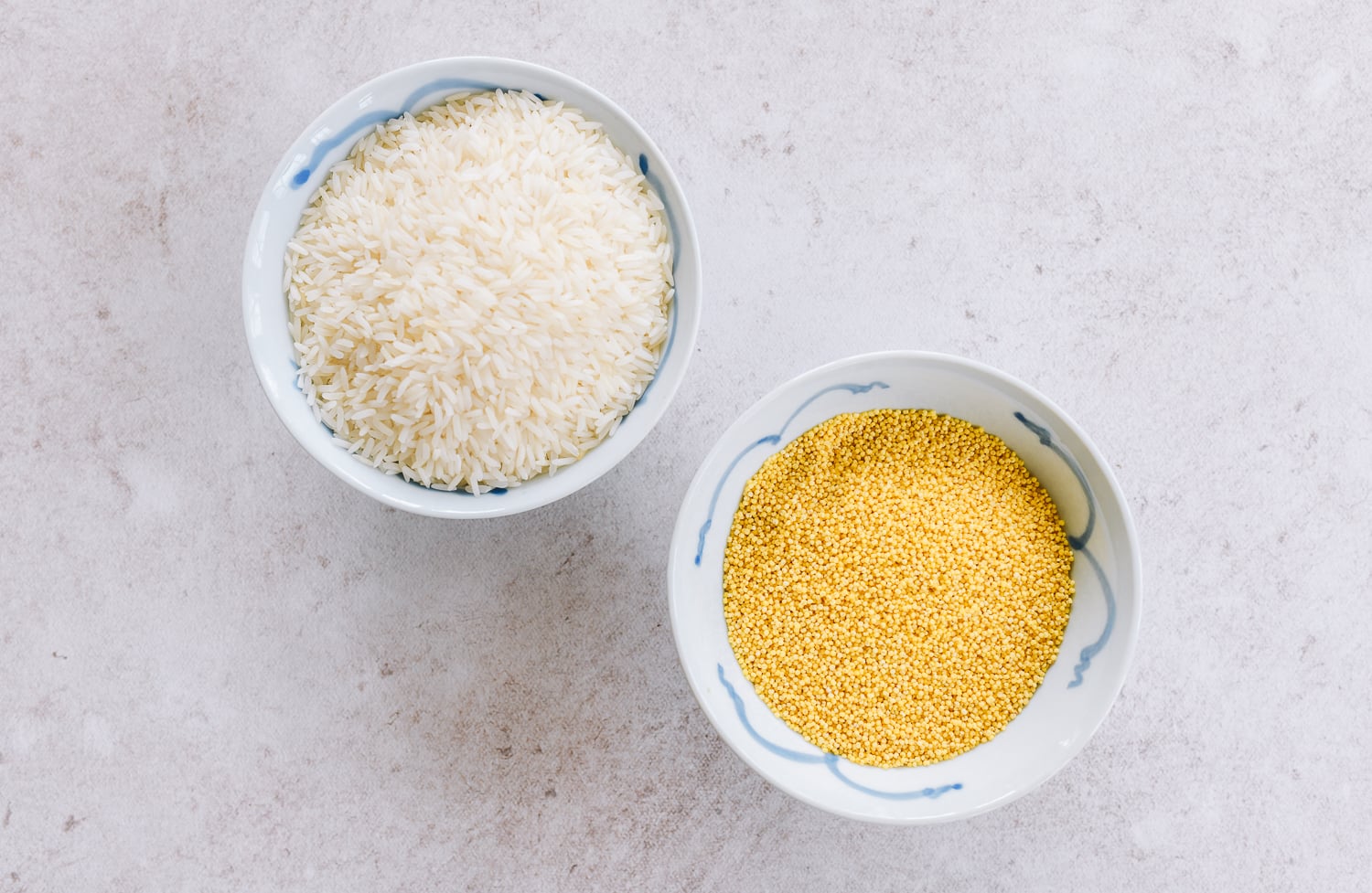 bowl of raw rice and bowl of raw millet