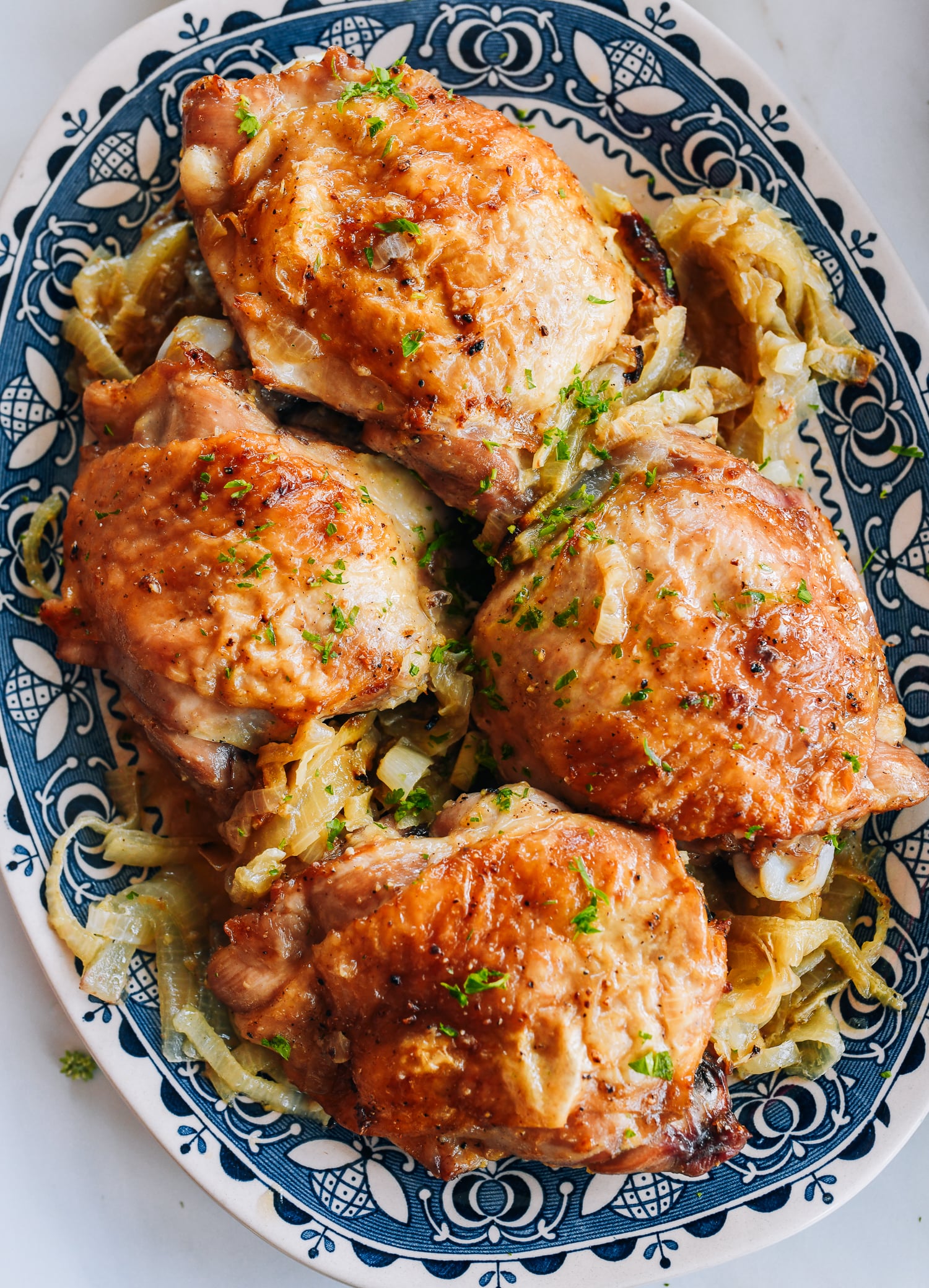 platter of roasted turkey thighs with onions