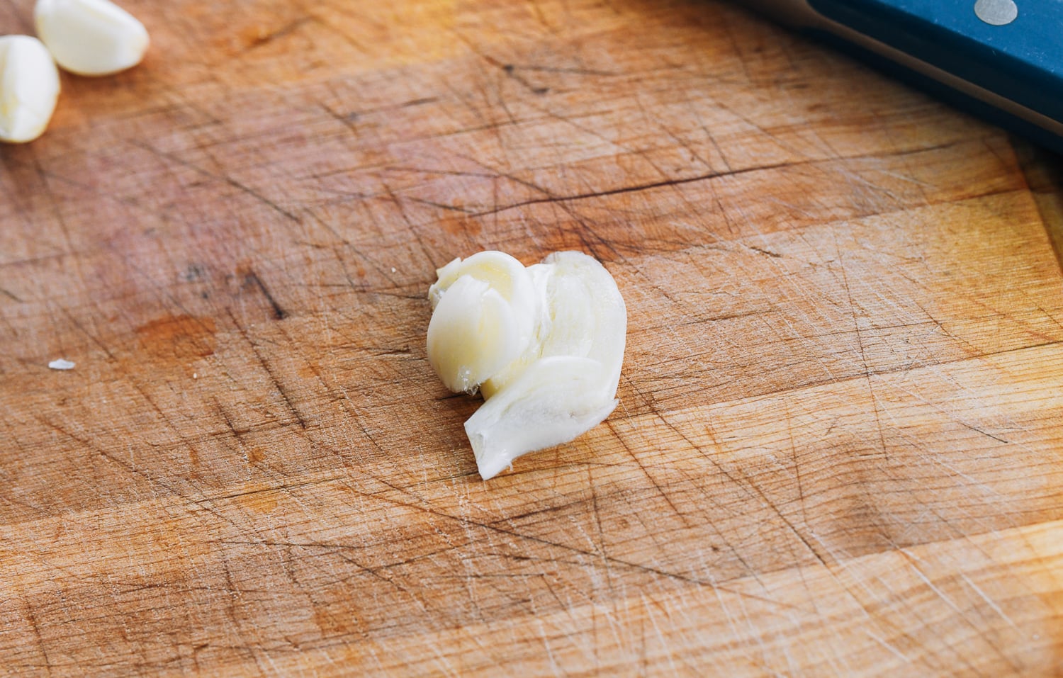 thin slices of garlic on cutting board
