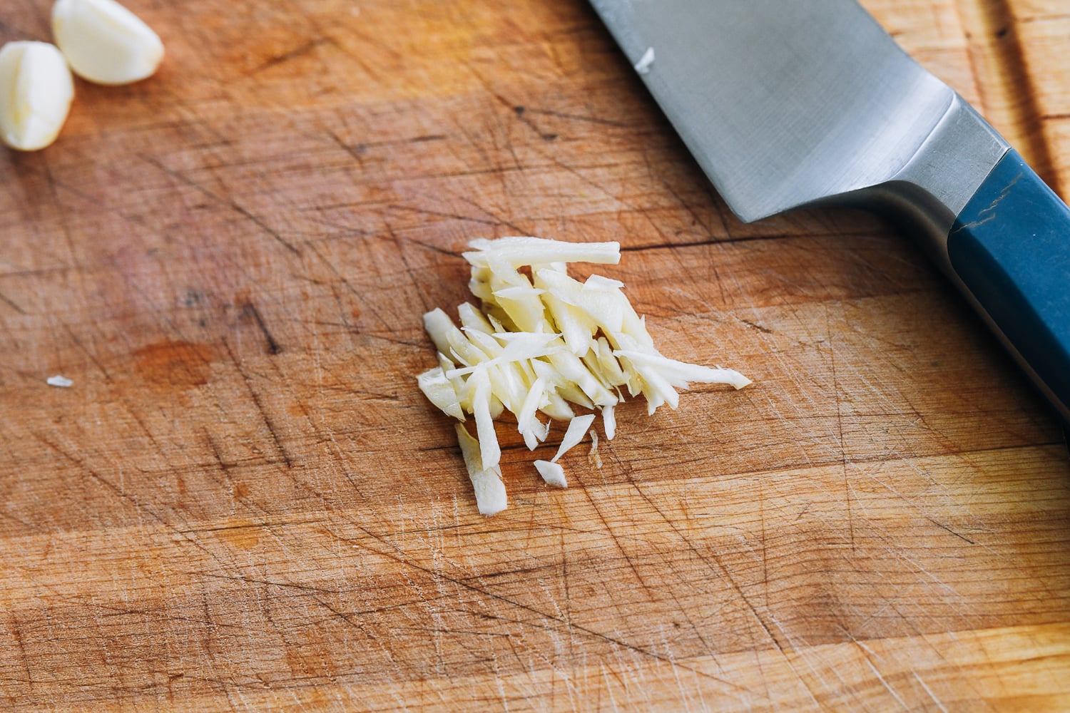 julienned garlic on cutting board