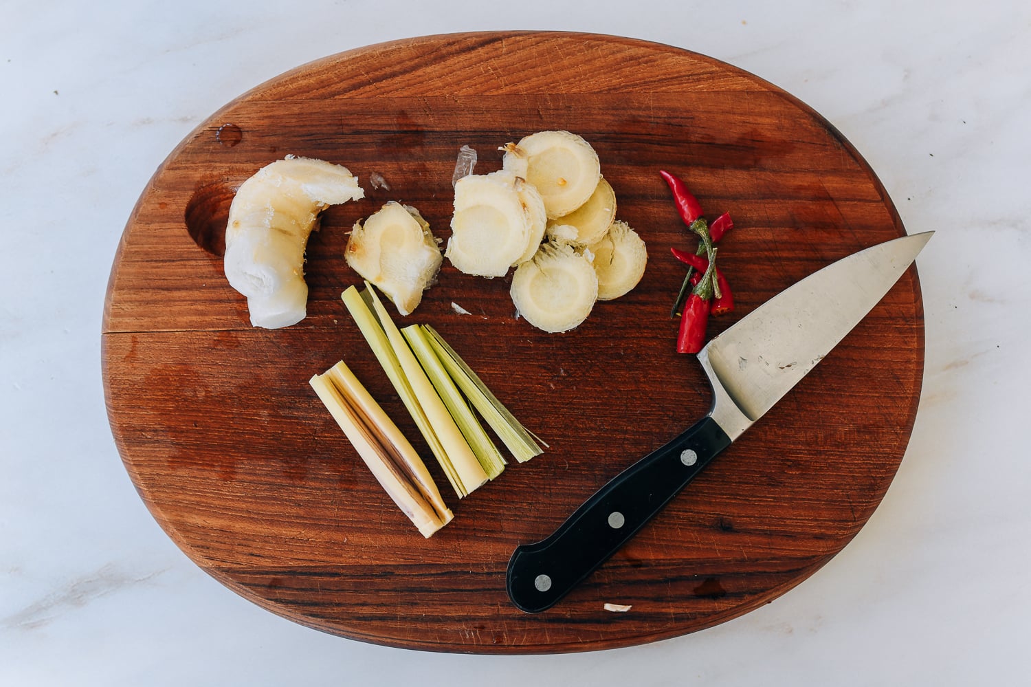 Cutting board with galangal, lemongrass, and chili