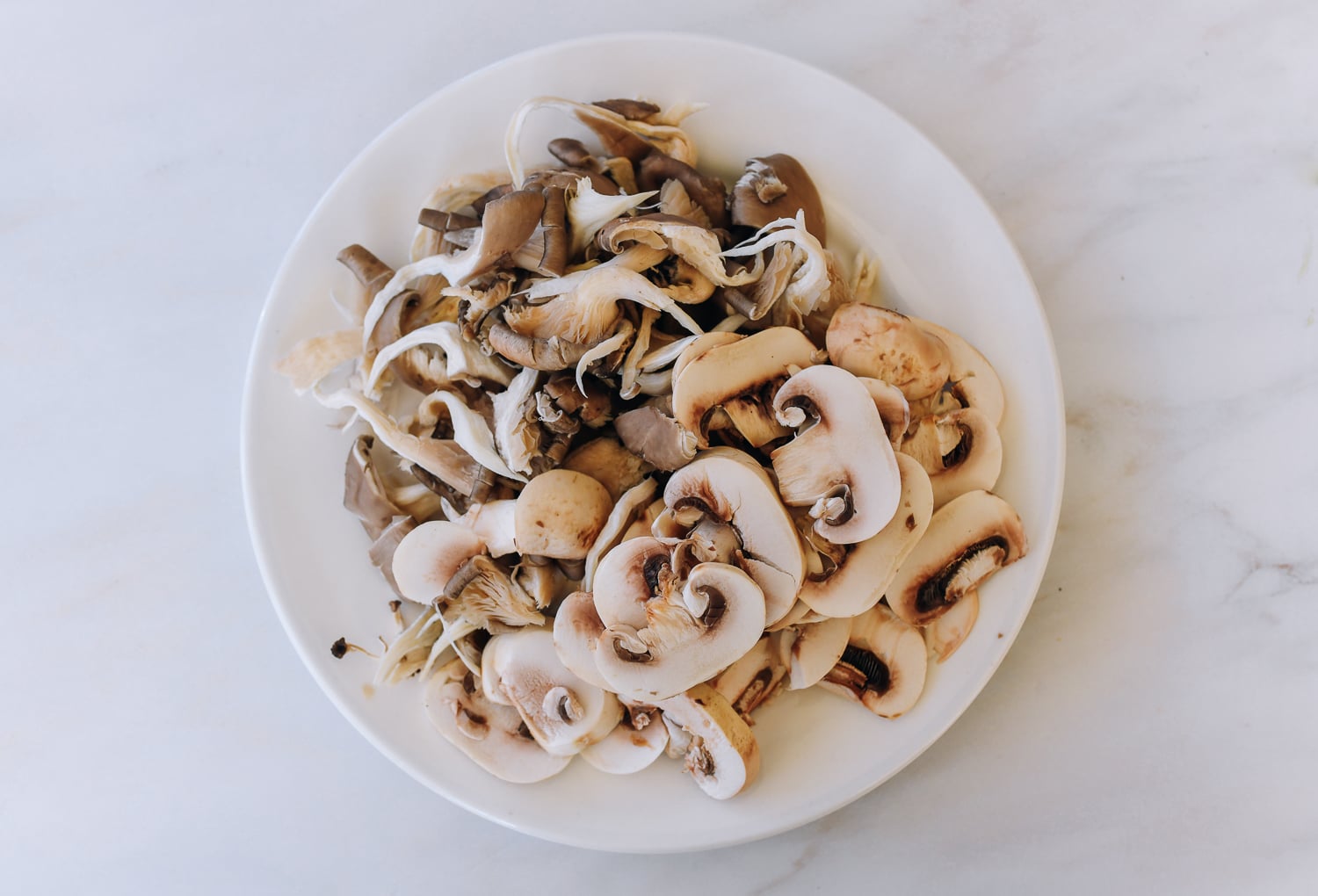 plate of mushrooms—oyster mushrooms and button mushrooms