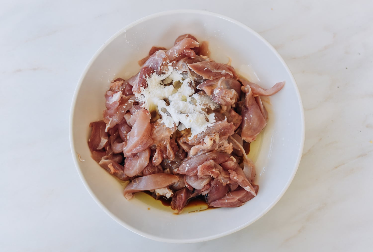 sliced boneless chicken thighs with fish sauce, oil, and cornstarch