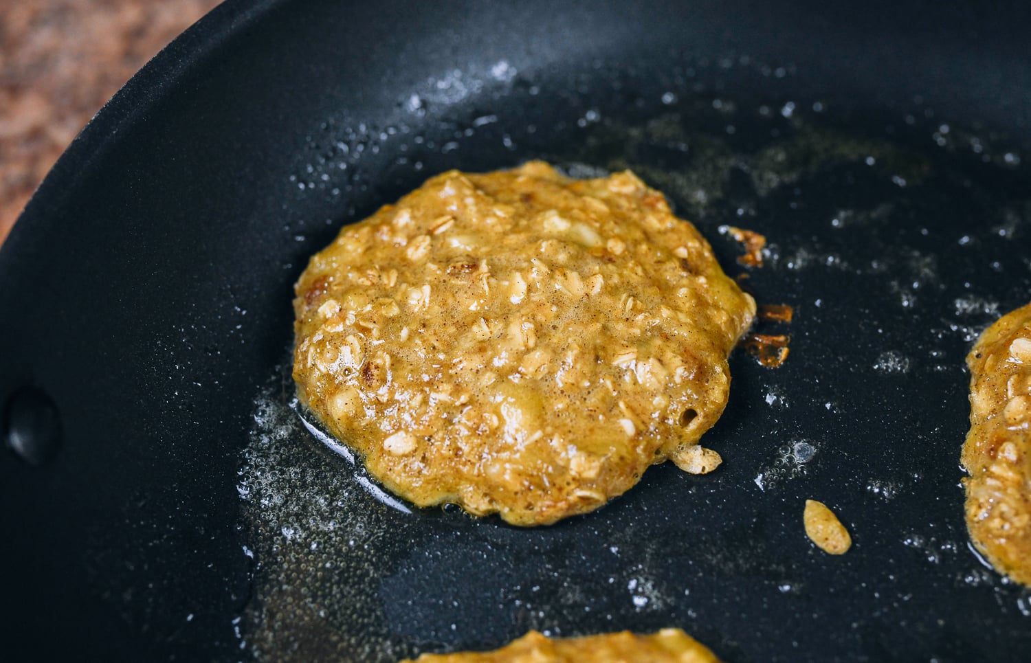 banana oat pancakes in pan