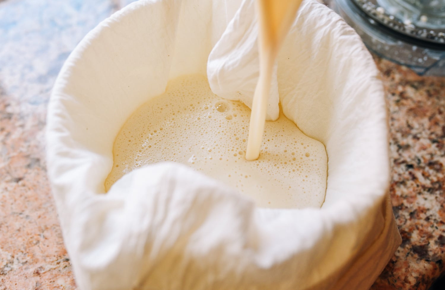 pouring chickpea and water puree into cheesecloth