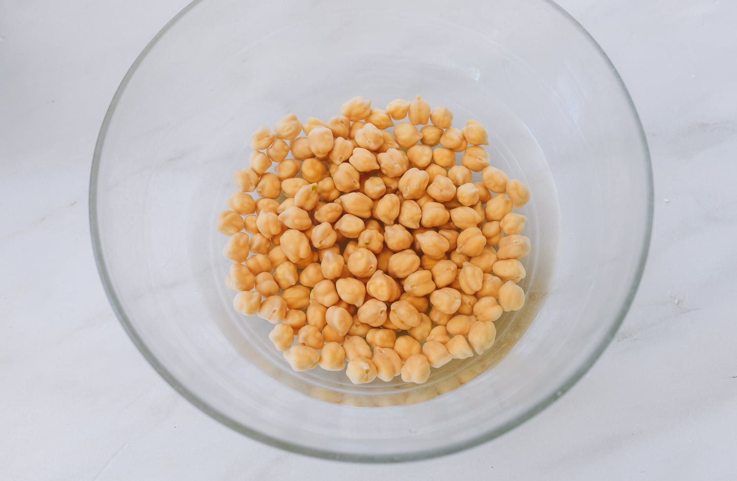 soaked chickpeas in glass bowl