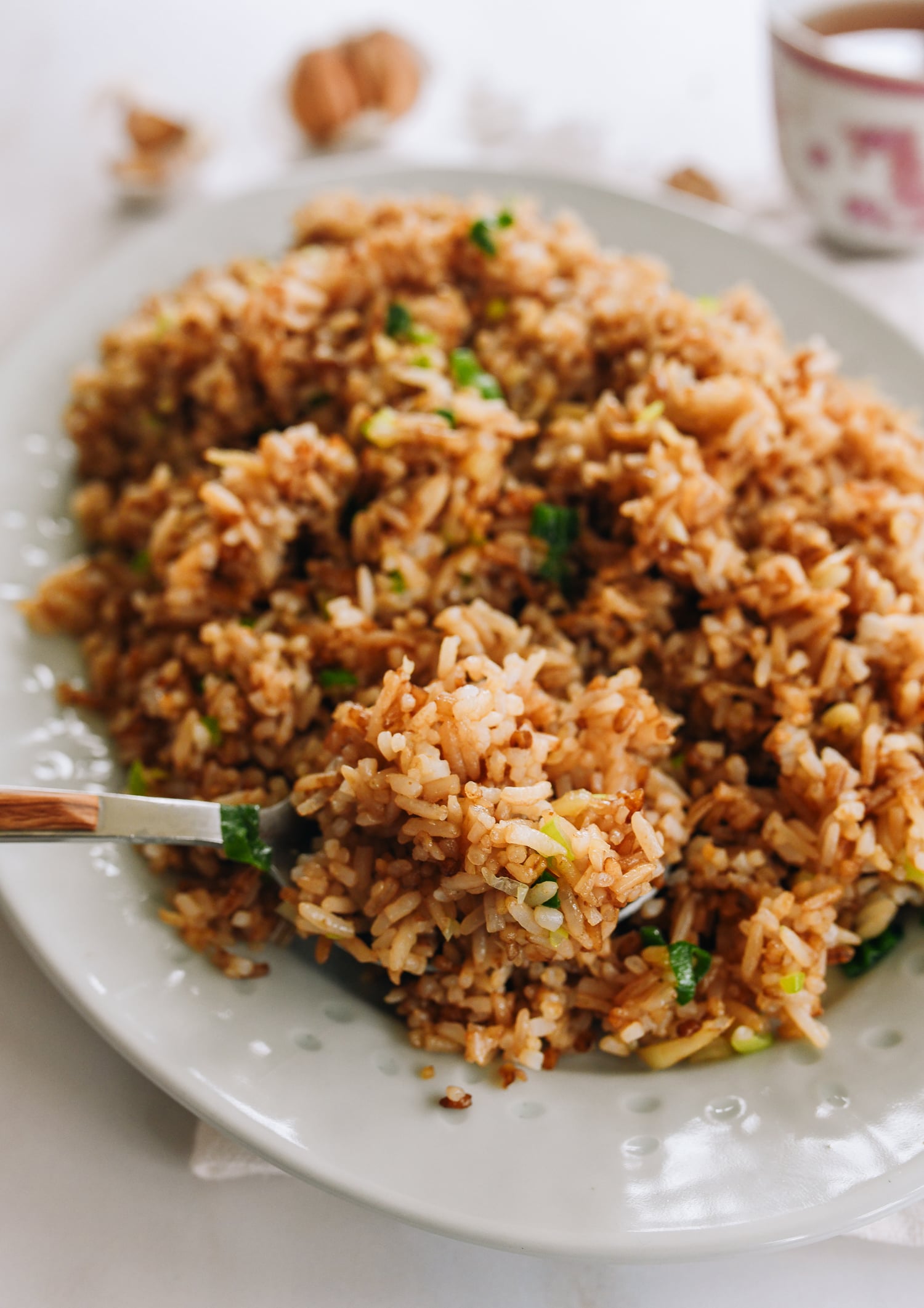 scooping garlic fried rice with a spoon