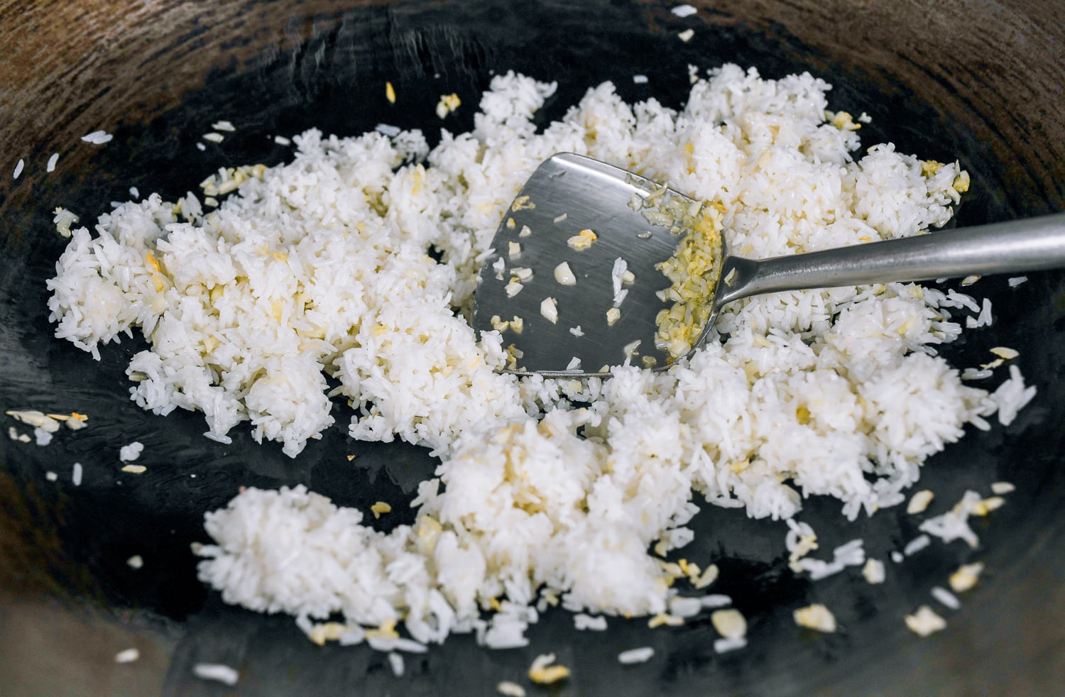frying rice to coat it in oil and garlic