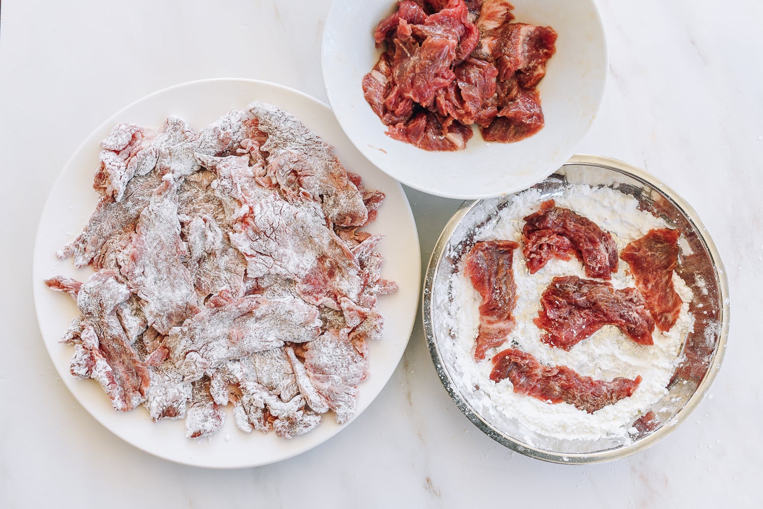 dredging beef slices in cornstarch