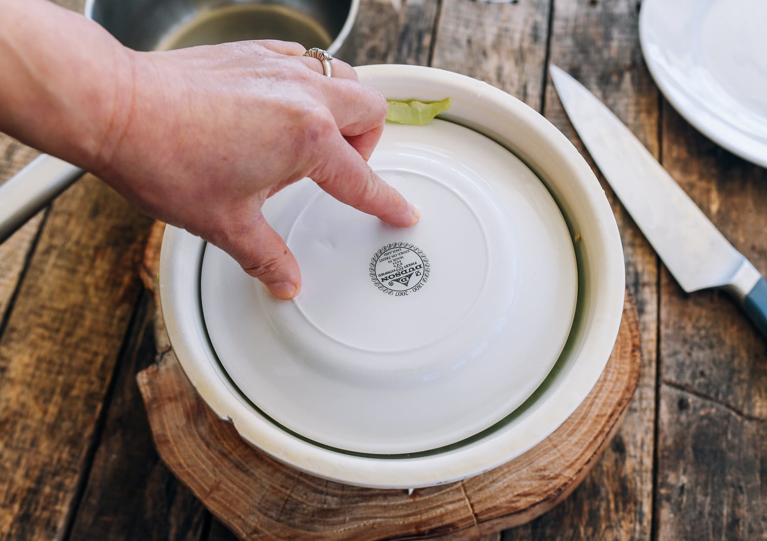 covering cabbage with a plate
