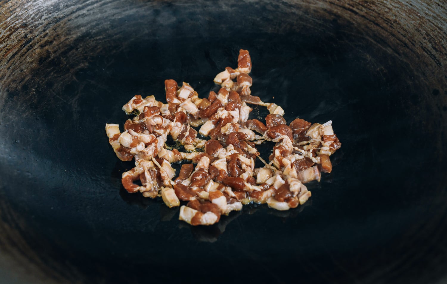 searing pork belly in wok