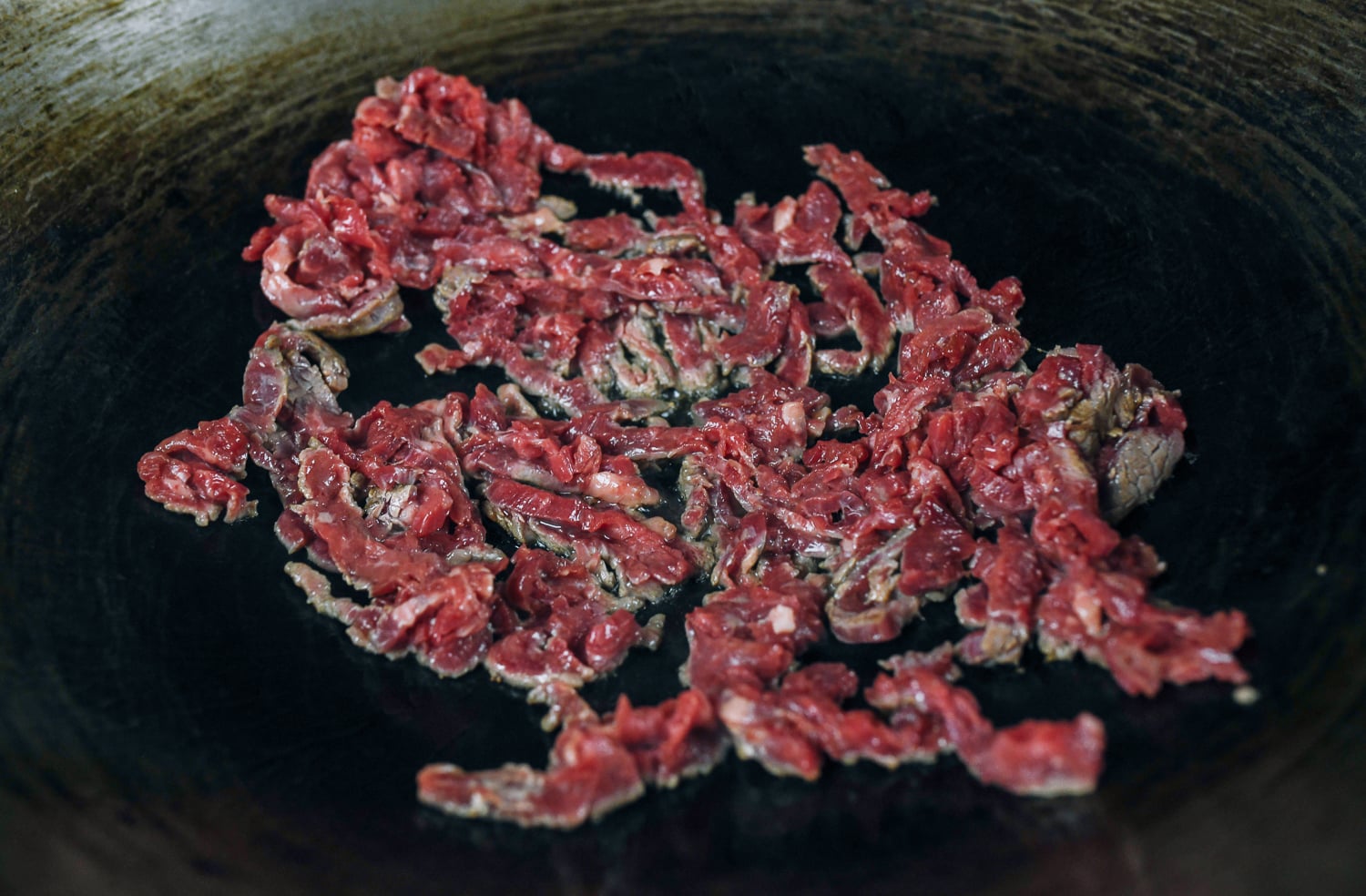 searing strips of beef in a hot wok