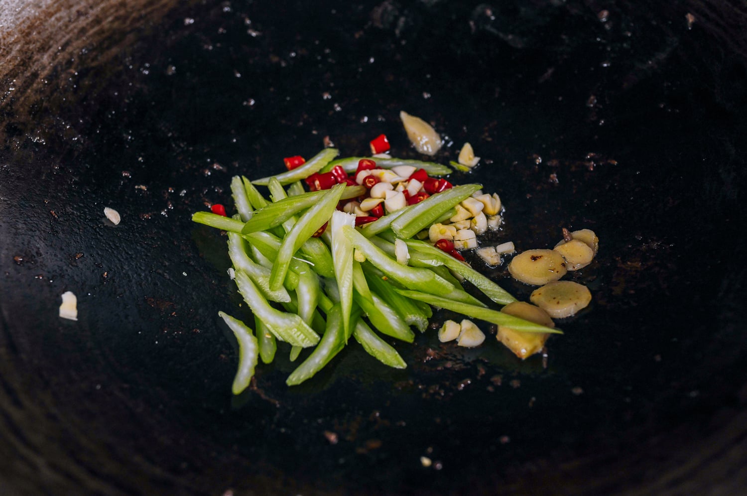 ginger, garlic, peppers, and celery in wok