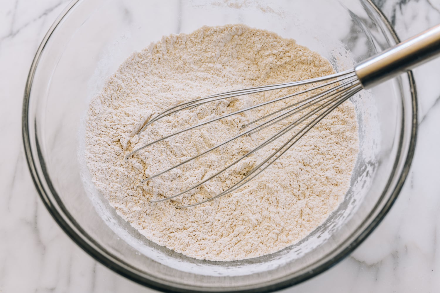 dry ingredients for sourdough english muffins in glass bowl