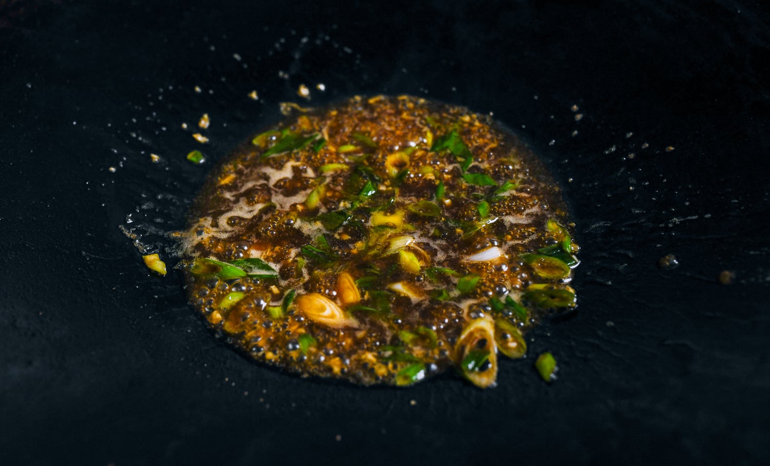 garlic soy butter sauce with scallions in wok