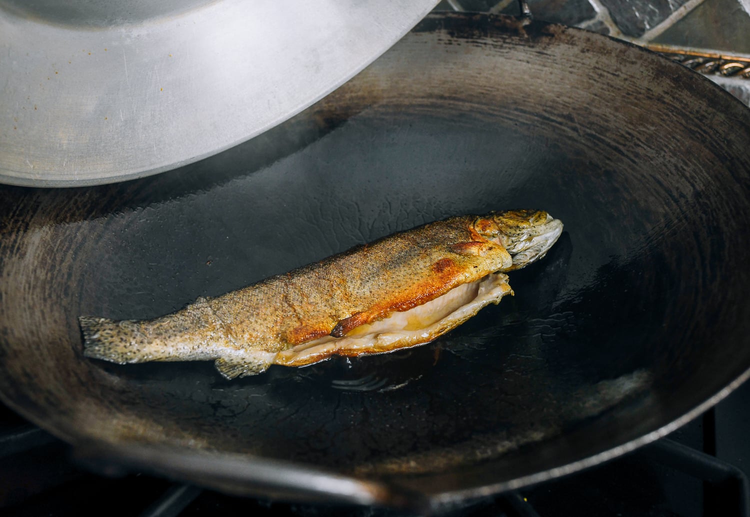 golden brown trout in wok