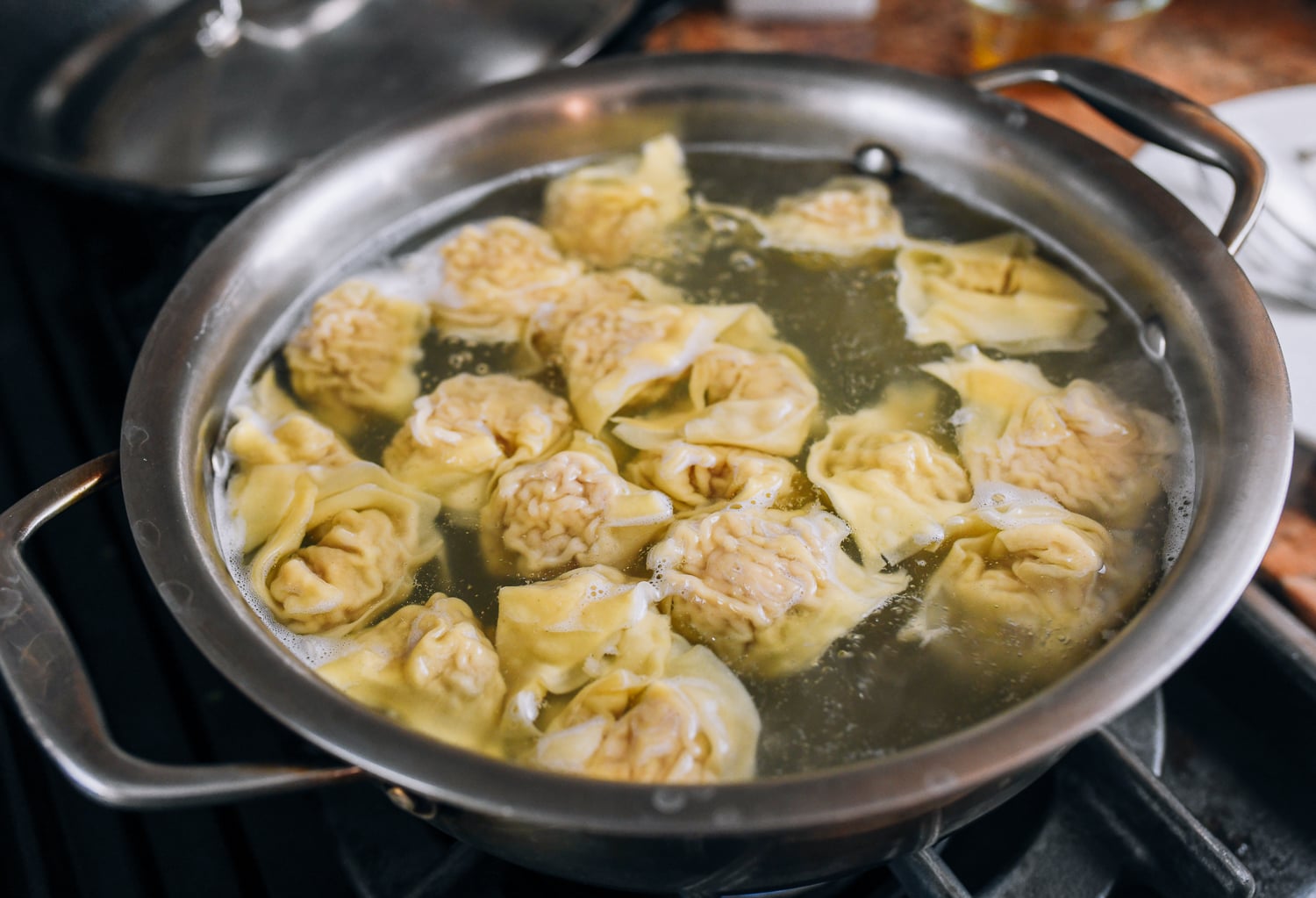 wontons floating in pot of water