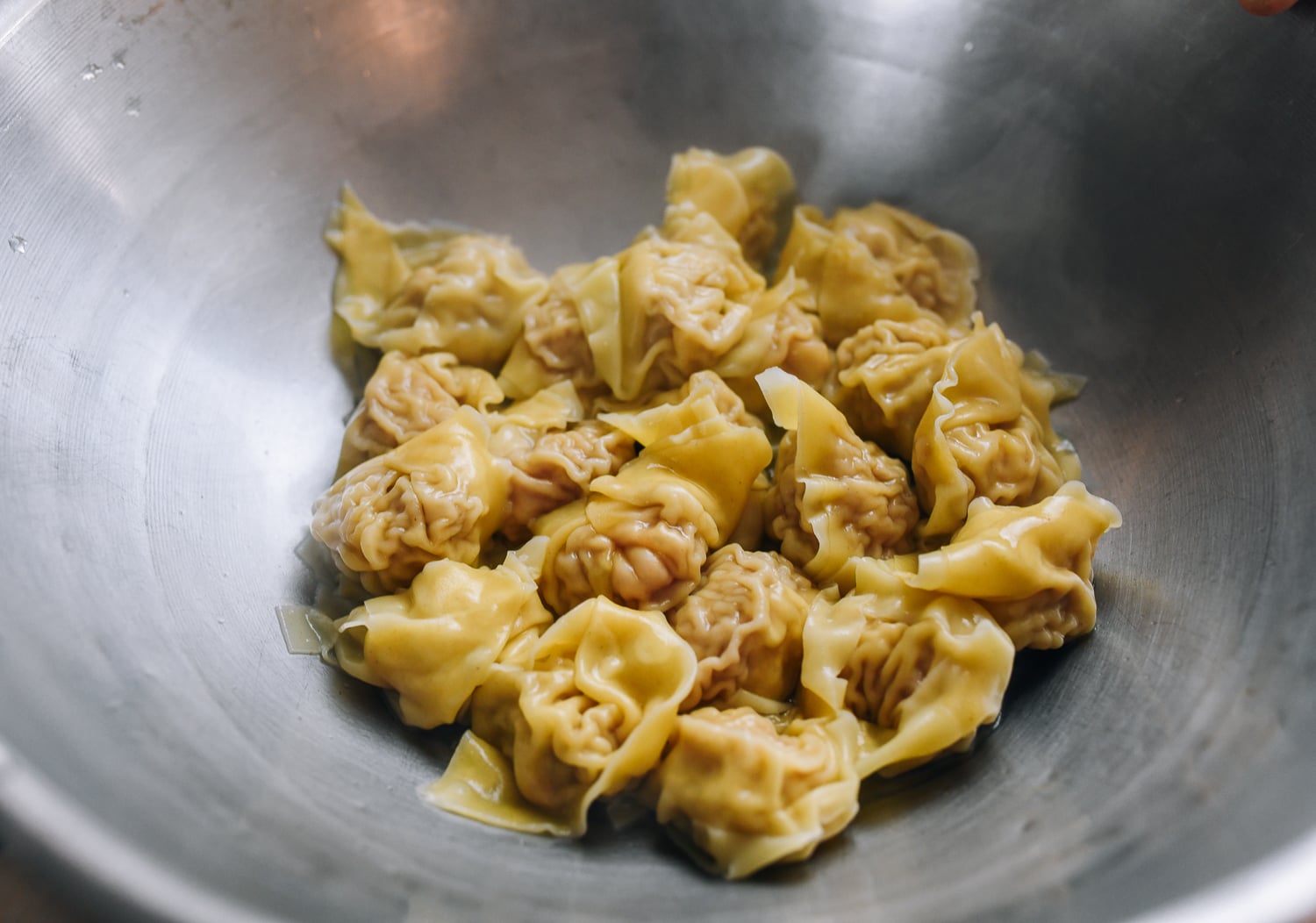 cooked wontons in metal bowl