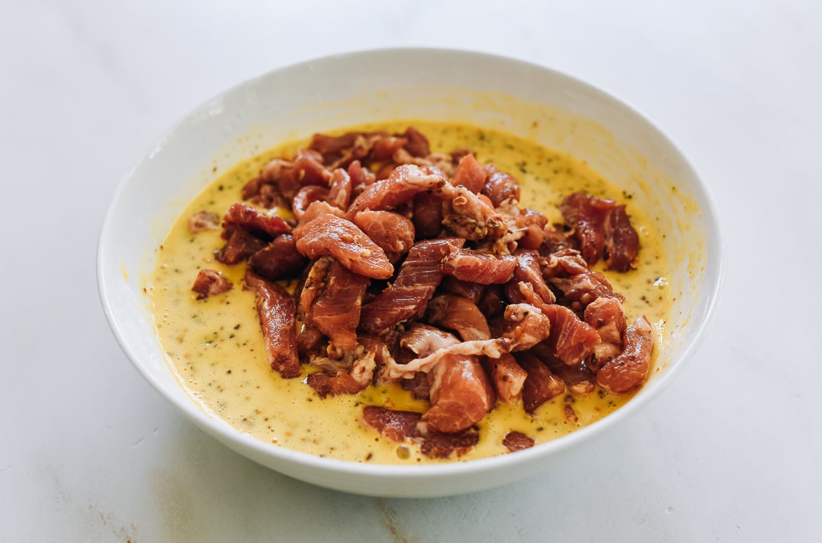 adding seasoned pork to batter