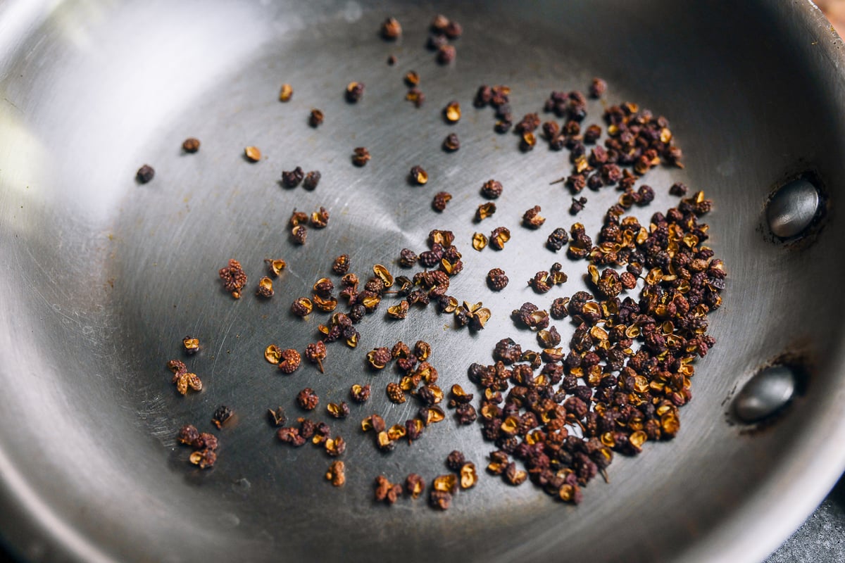 sichuan peppercorns toasting in dry pan