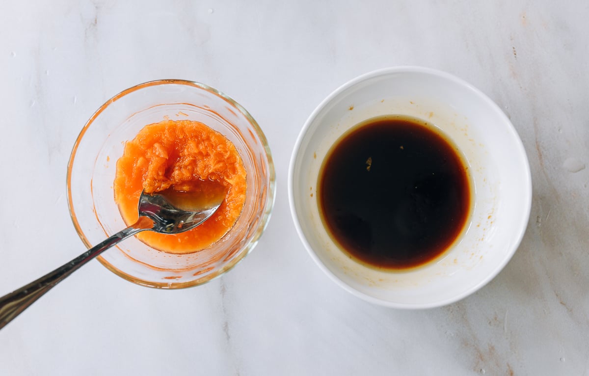 chopped mandarin orange in one bowl, and soy-based dressing ingredients in another bowl