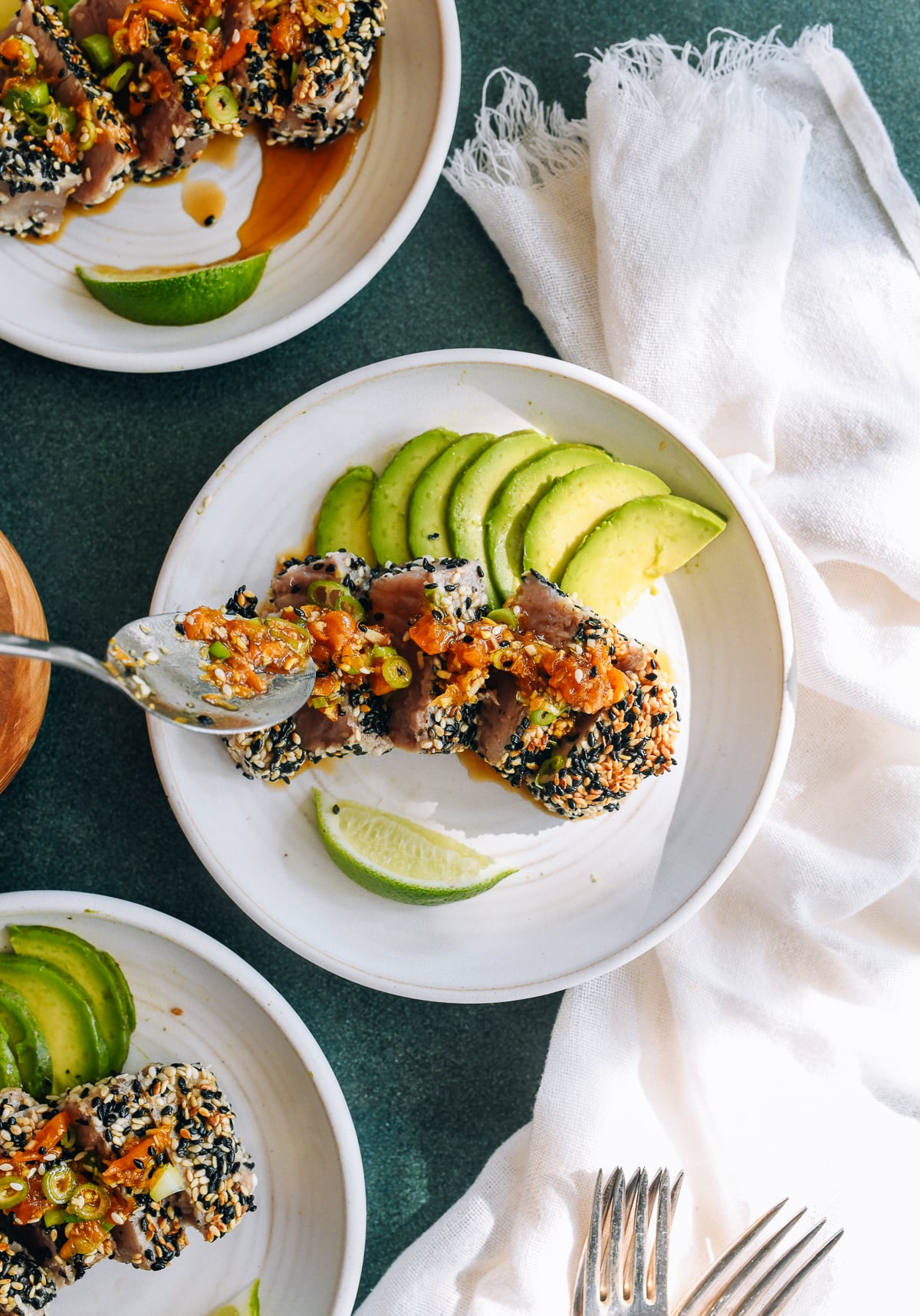 spooning dressing over sliced ahi tuna