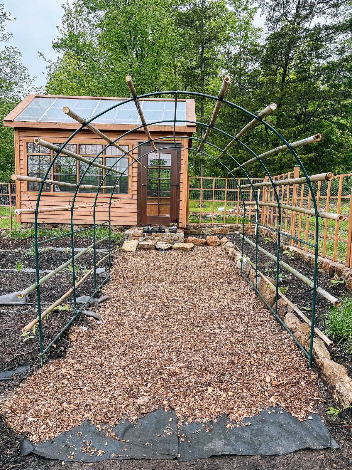 arch with bamboo poles running across it