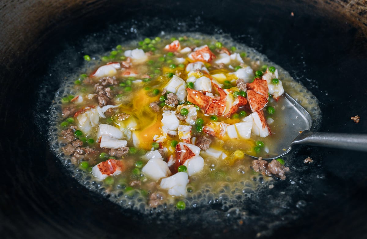 egg added to lobster with lobster sauce in wok