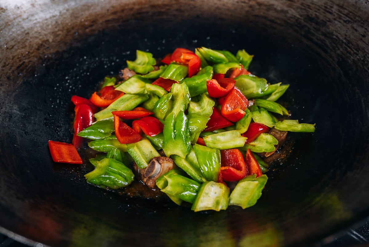 bitter melon and bell pepper added to wok