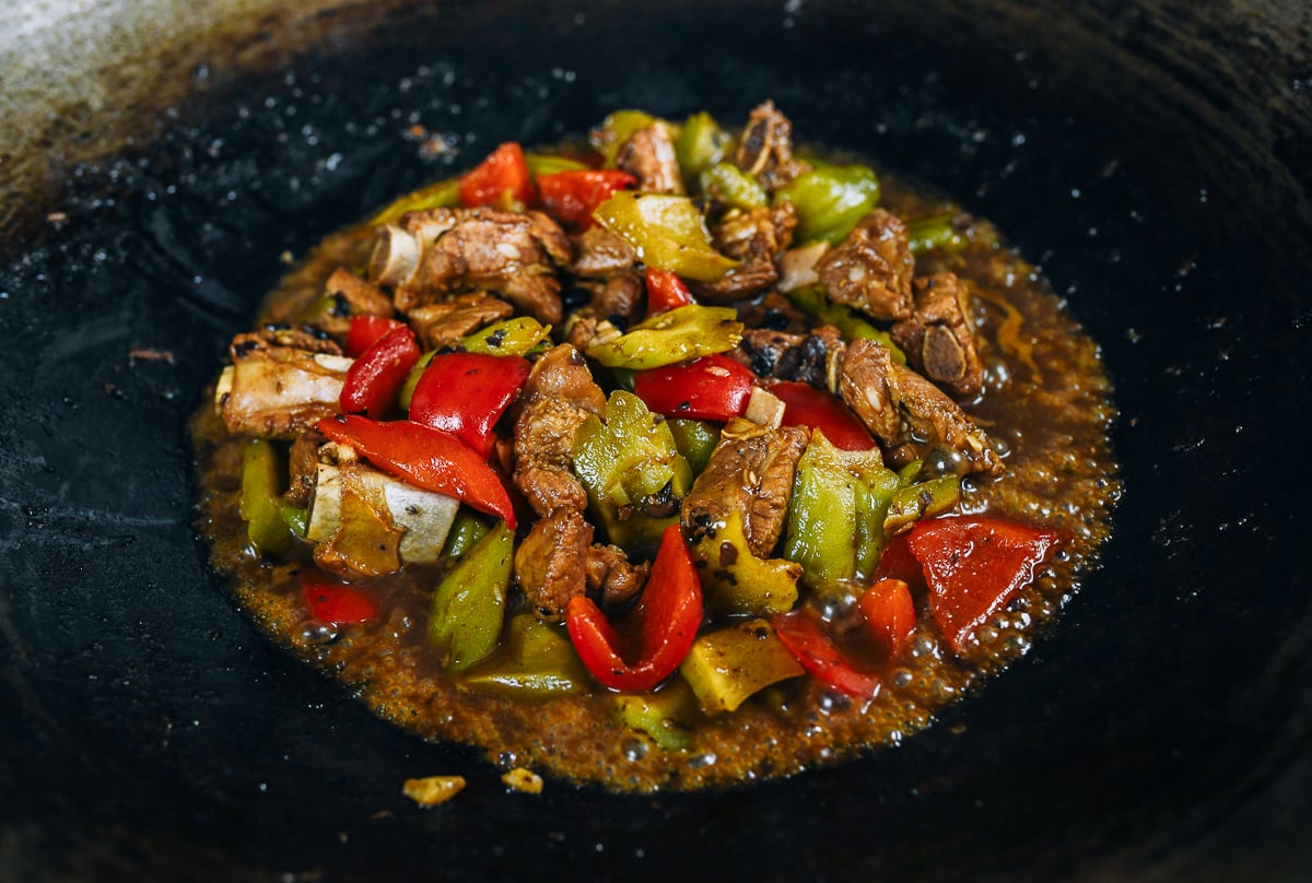 braised ribs with bitter melon and peppers in wok