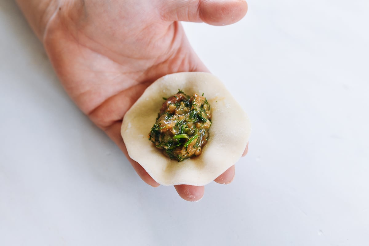 dill dumpling filling in the middle of homemade wrapper