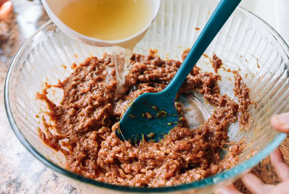 mixing seasoned water into ground pork