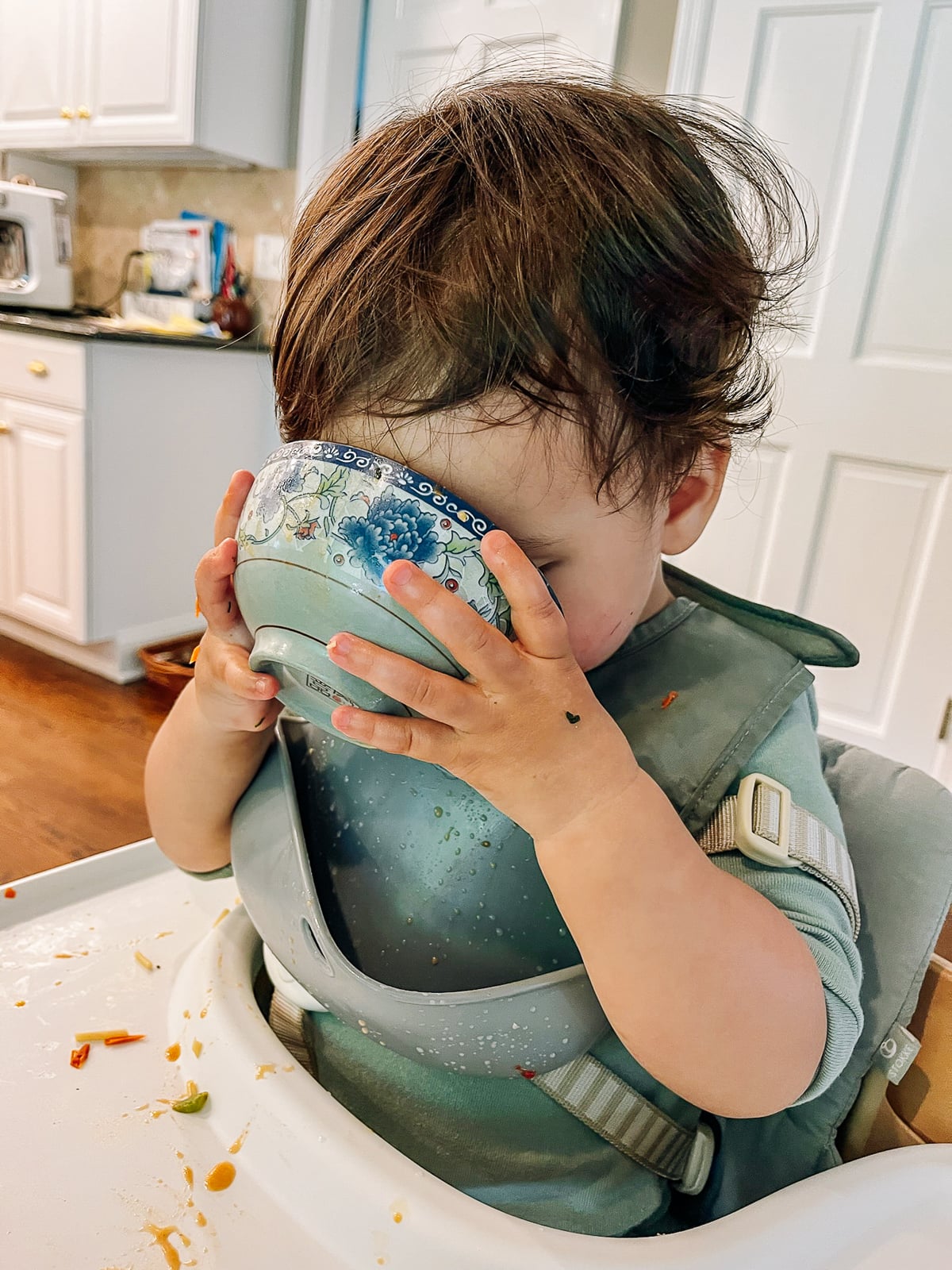 Ethan drinking soup out of Chinese soup bowl