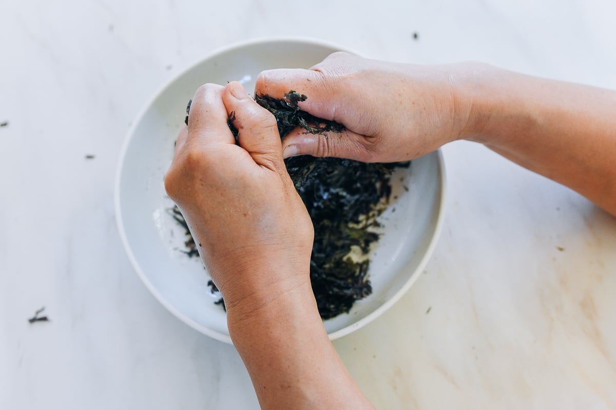 breaking up toasted seaweed into smaller pieces
