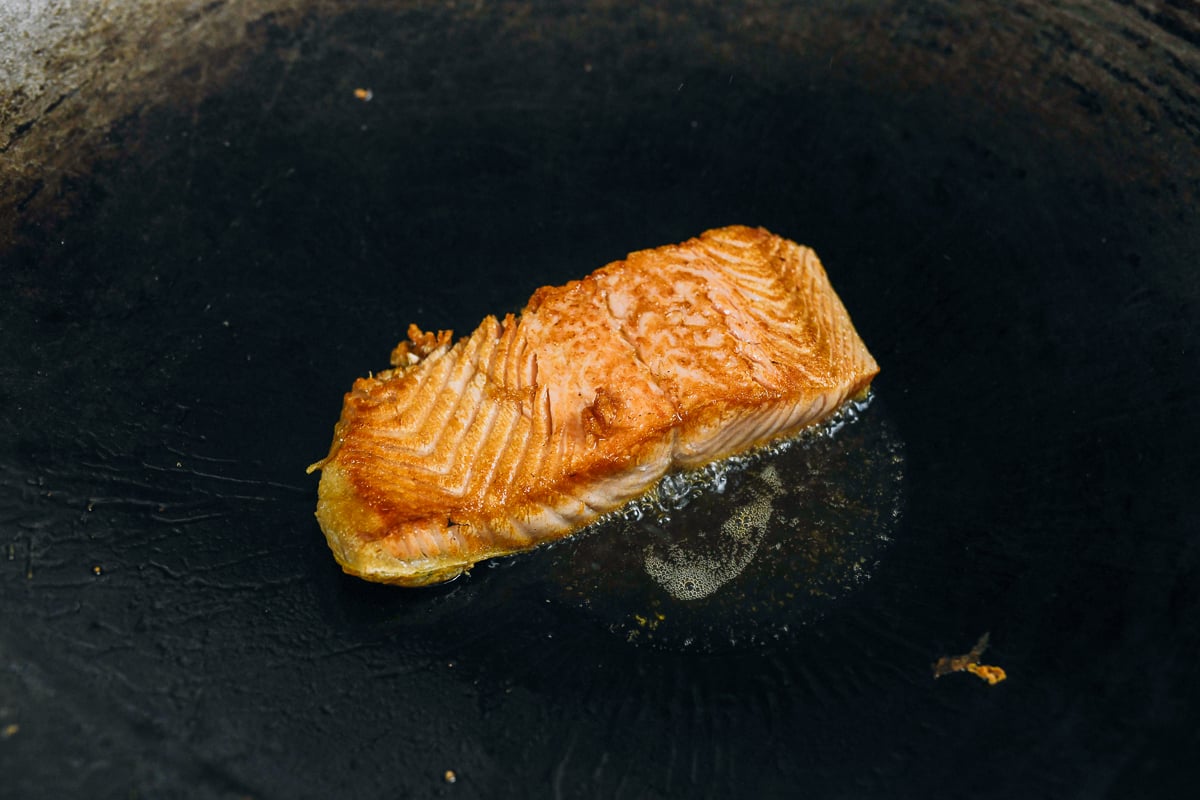 seared salmon fillet in wok