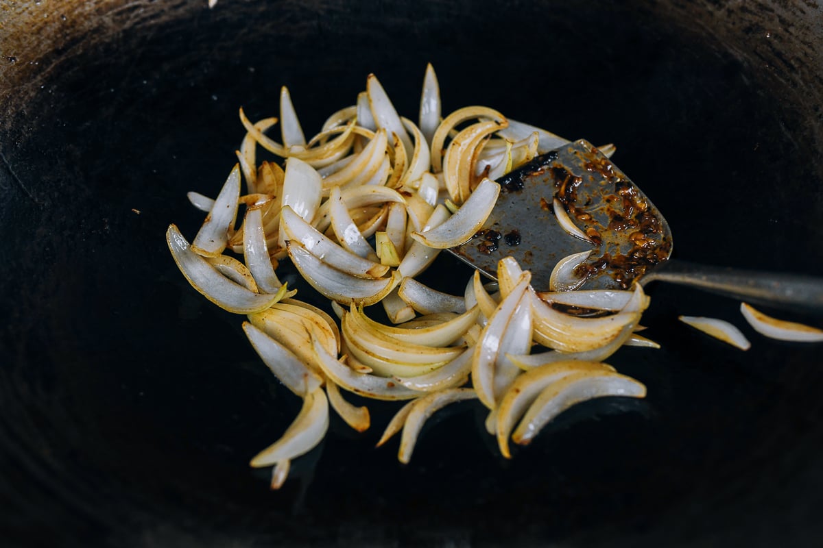stir-frying onions in wok