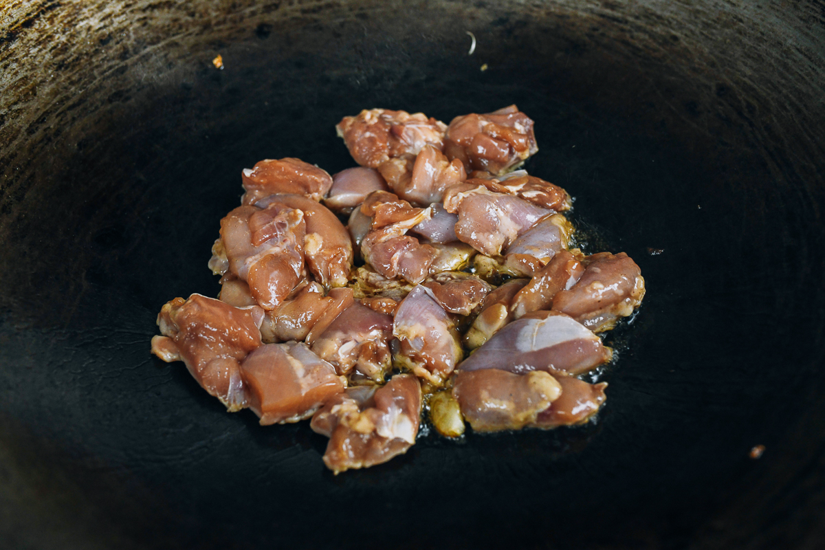 searing chicken thigh pieces in wok