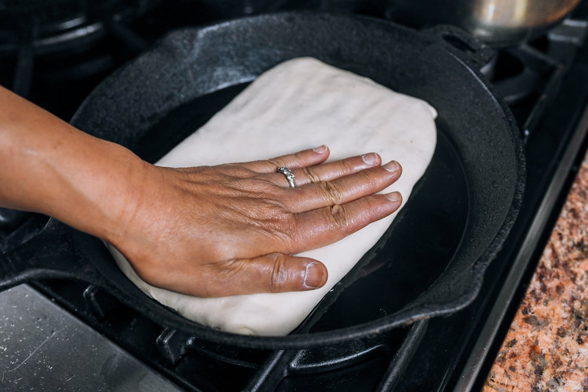 pressing meat pie in pan