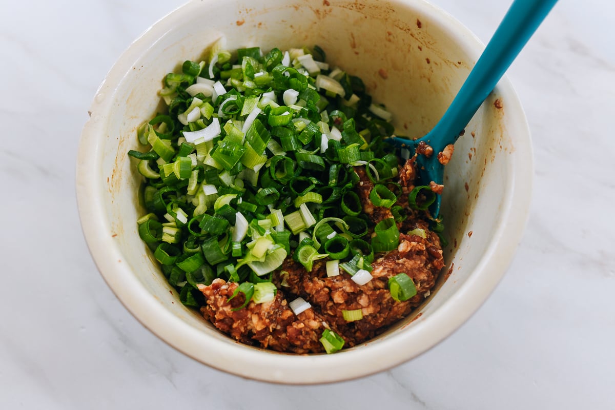 chopped scallions added to meat filling