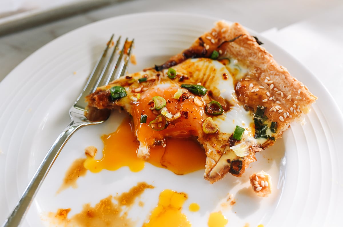 eating Chinese eggs in puff pastry with runny yolk