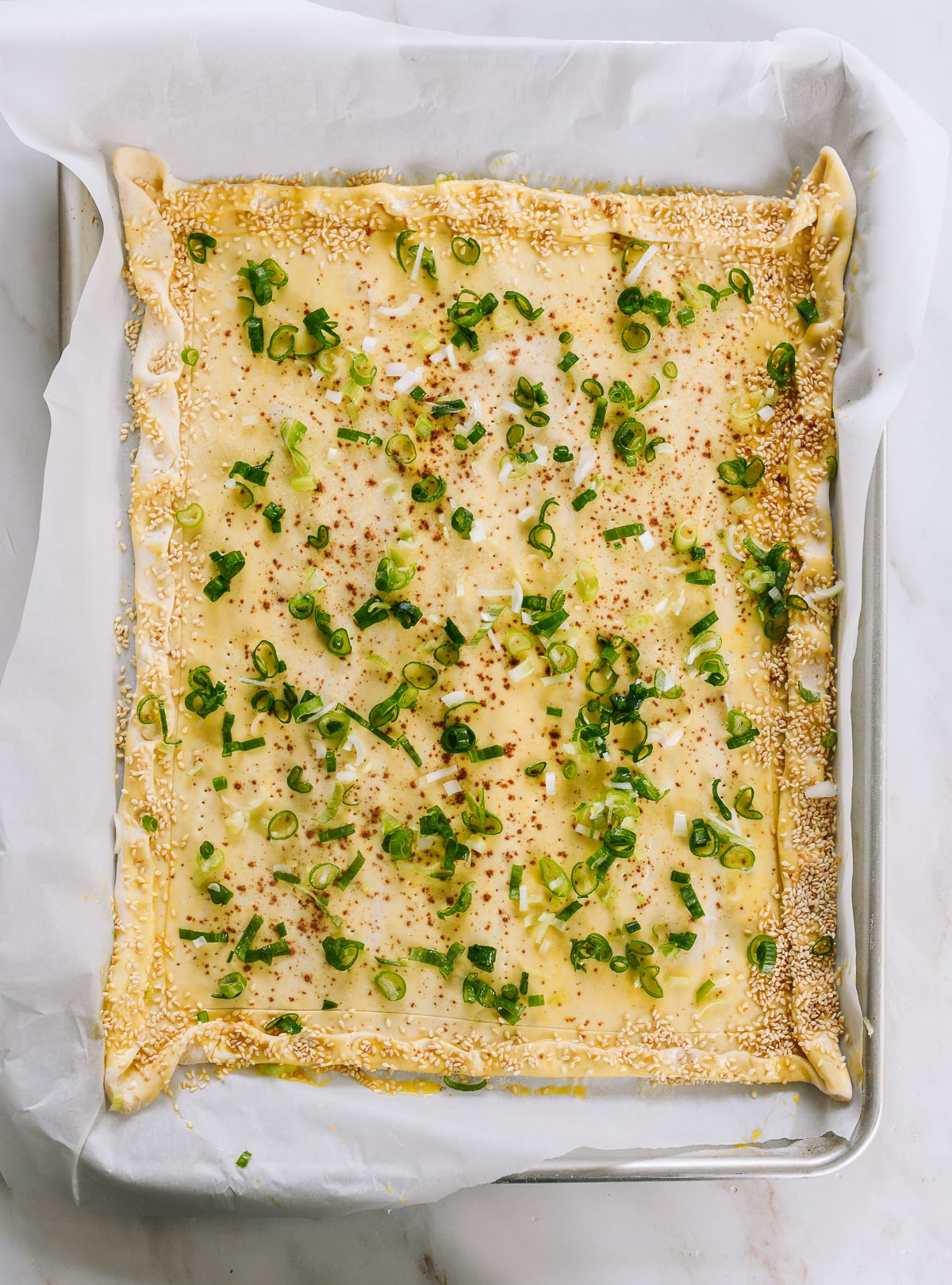 scallions, five spice powder, and salt sprinkled over puff pastry