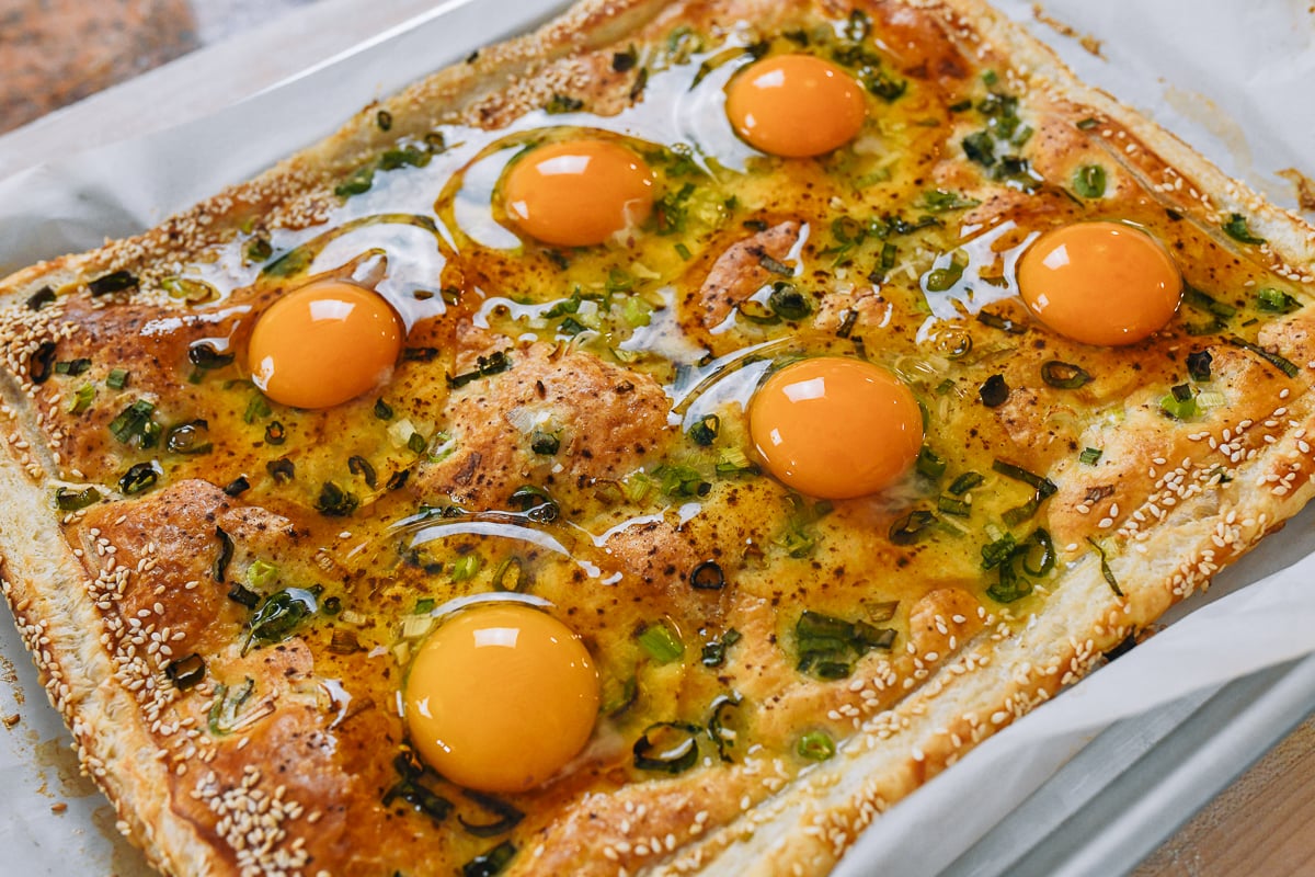 eggs cracked onto puff pastry