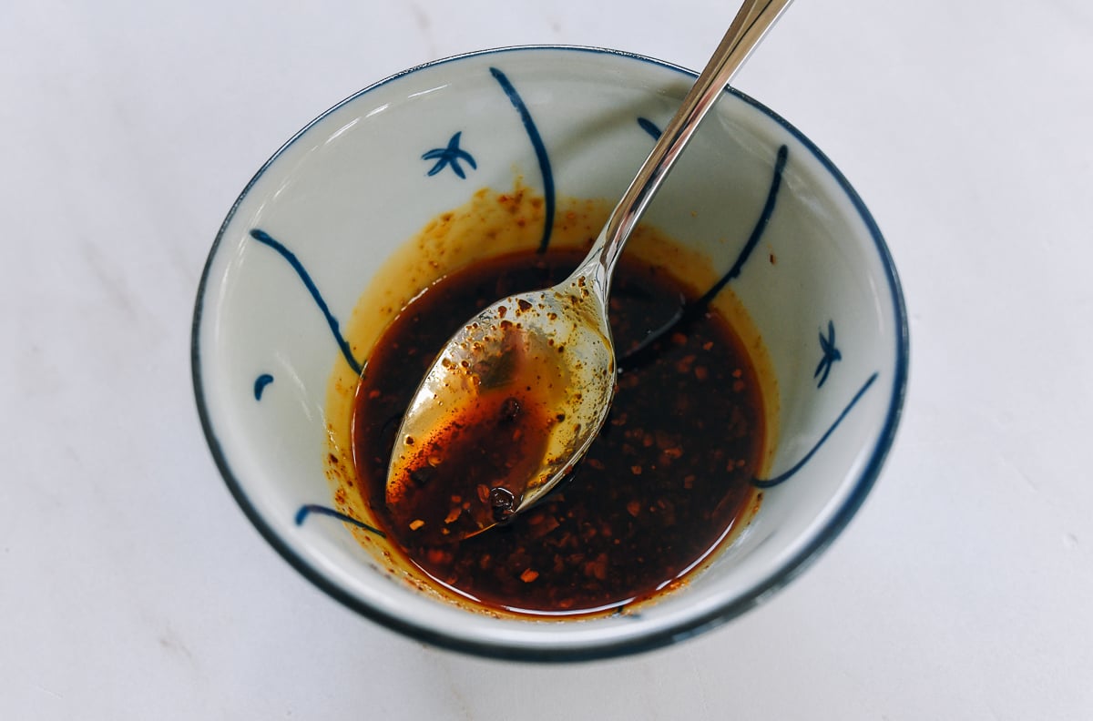 soy sauce mixed with chili oil in a bowl with spoon