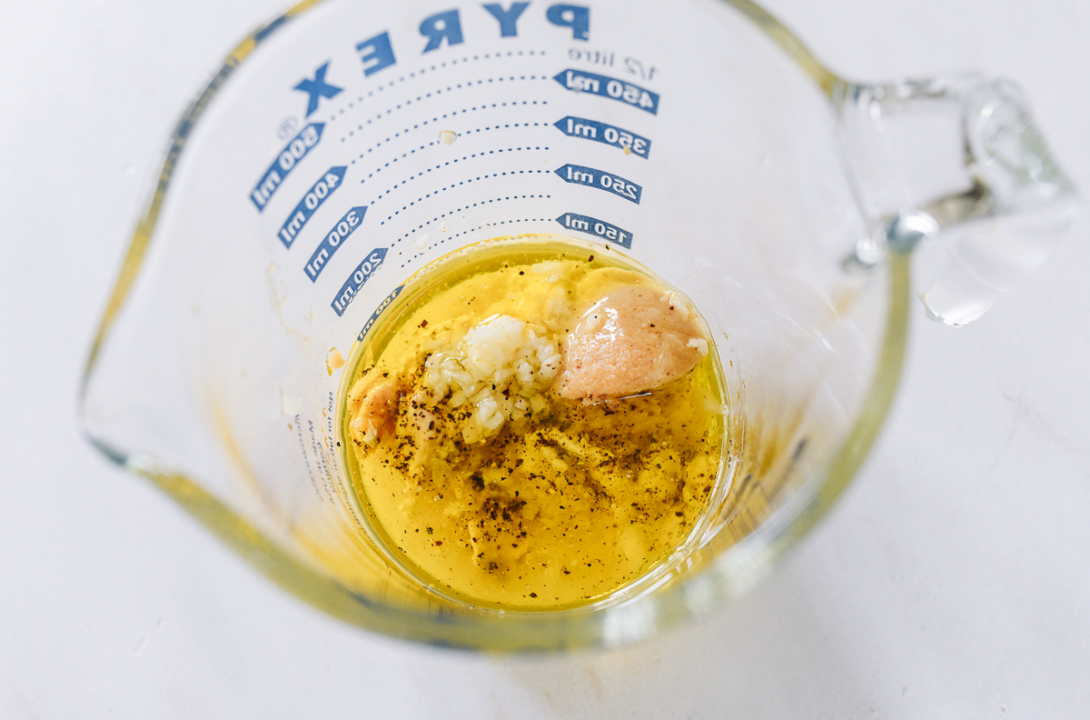 miso caesar dressing ingredients in measuring cup