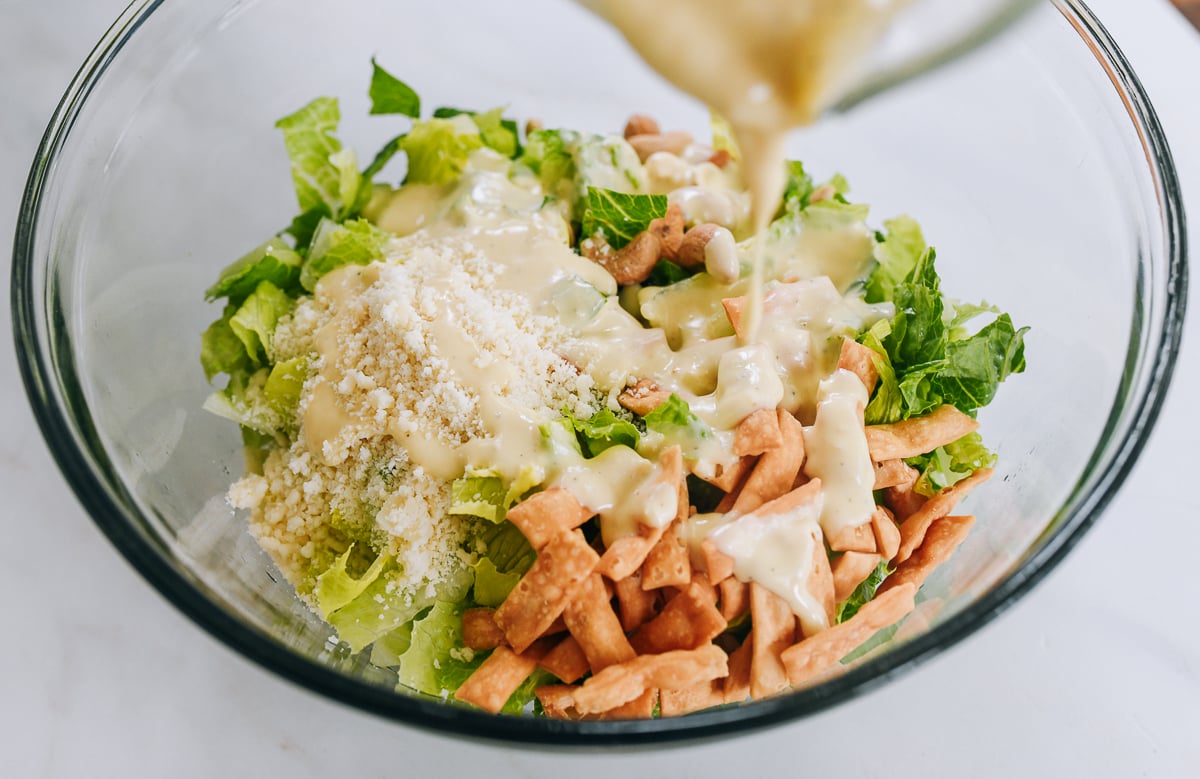 pouring dressing over salad