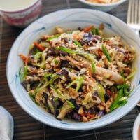 Egg Roll in a Bowl garnished with scallions and sesame seeds, served with wonton chips