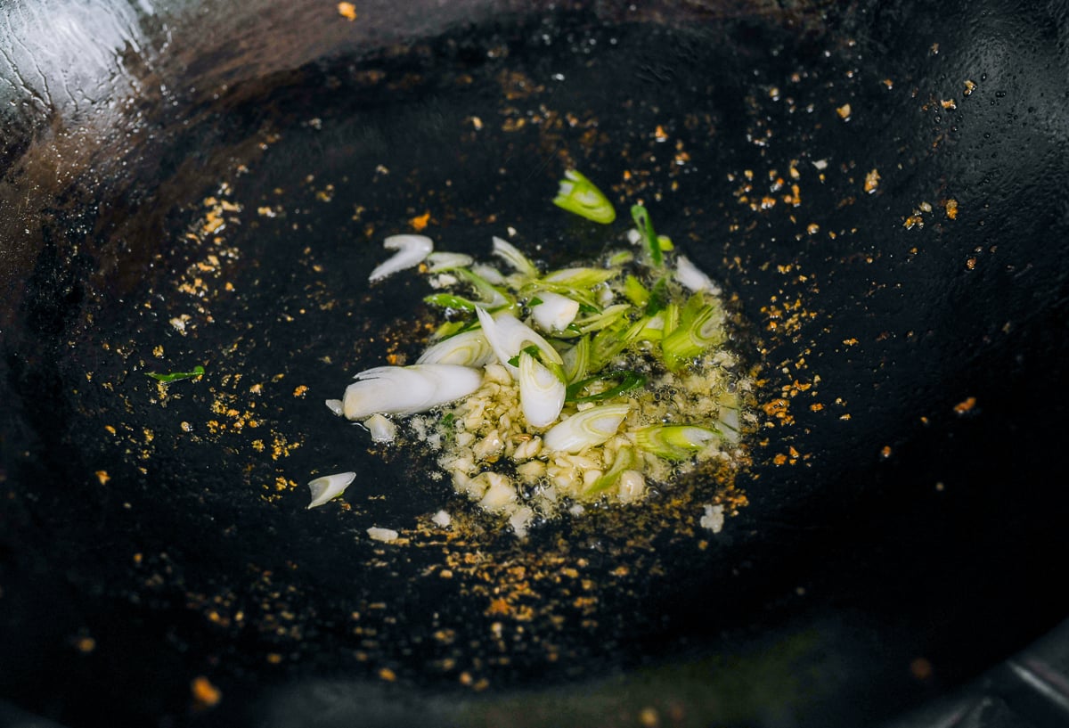 garlic and white parts of scallions in wok